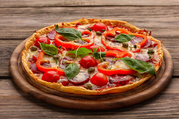 Delicious pizza served on wooden plate