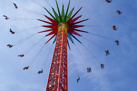 Oktoberfest chain carousel from below against blue sky
