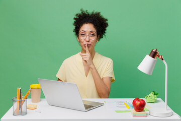 Young employee business woman of African American ethnicity in shirt sit work at white office desk...
