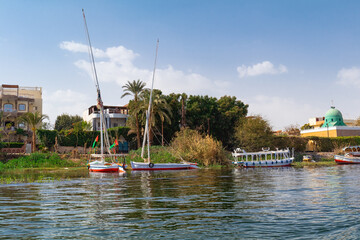 Traditional Egyptian felucca boats moored   on the banks of  the Nile, Egypt - obrazy, fototapety, plakaty