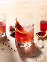 Refreshing cocktail with bloody oranges,ice,juice and tonic water on hard light.Close up of fresh drink.
