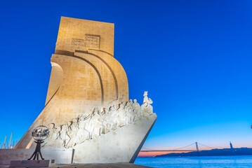 Sunrise view of Monument of the Discoveries in Belem and bridge of 25th April , Lisbon, Portugal