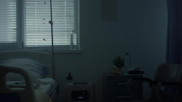 Upset woman visiting sick child after therapy. Hospital operating ward interior