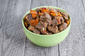 Stewed veal with onions, carrots and pine nuts. Rustic style, the concept of delicious food
