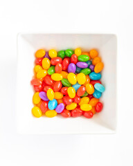 A bowl of jelly beans on a white background.