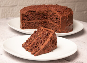 Date, chocolate and sweet potato cake with cut slice on seperate plate