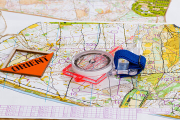 Sport orienteering. Symbols of the sport Topographic map, compass and prism with the inscription Orient