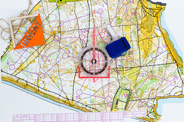 flatlay orienteering. topographic map, professional compass and prism