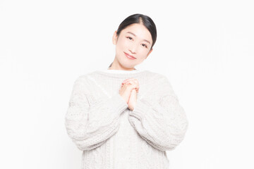 指を組んでお願いする女性