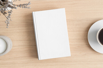 Obraz na płótnie Canvas White book mockup with a lavender and a cup of coffee on the wooden table.