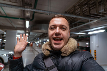 Millennial caucasian confident man standing in underground parking lot in residential building