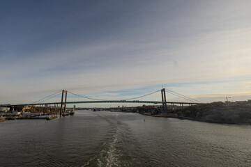 View of magnificent Älvsborgsbron bridge in Gothenburg as viewed from the passing ship. Cloudy overcast day.