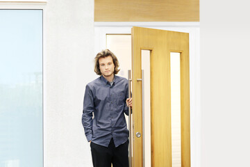 man opening the door of his home.