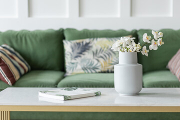 Fototapeta na wymiar Cozy home interior with a green sofa. White walls