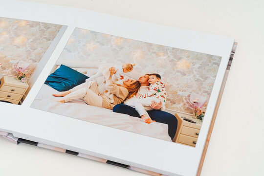 a book with photos of big family at home on a white background.