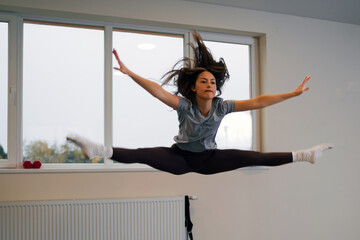 Young attractive woman doing fitness exercises in a gym