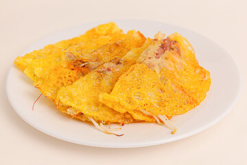 Banh xeo, Vietnamese Crêpes or Pancakes with pork, shrimp, onions, beasn sprouts inside, Vietnamese food isolated on white background. close-up