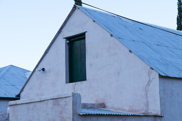 Old Plastered Farmhouse With Attic Door Abstract