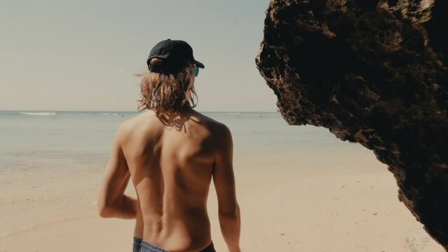 Man walking on a beach in Bali