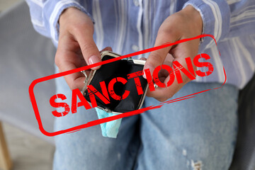 Woman with empty wallet, closeup. Concept of sanctions
