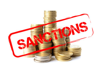 Many coins and word SANCTIONS on white background