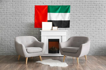 Interior of modern living room with armchairs, fireplace and UAE flag