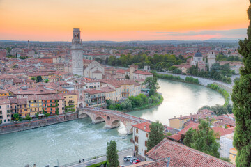 Sunset over Adige riverside in verona with church san giorgio in braide and cathedral santa maria...