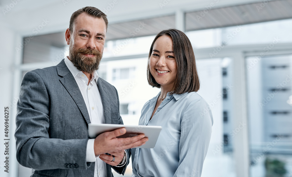 Poster bringing different expertise and perspectives together. portrait of two businesspeople using a digit
