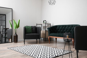 Black armchairs with sofa in interior of modern living room