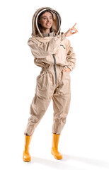 Female beekeeper in protective suit pointing at something on white background