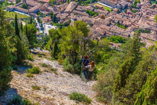 People are enjoying ride at Funivia Colle Eletto in Gubbio, Italy