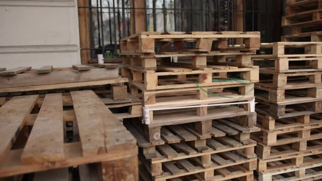 Freight delivery. Shipment. Delivery service. Pallet for packing boxes waiting to be loaded onto a container truck. Supply chain. Logistics and transportation. Stack of wooden pallets for industrial