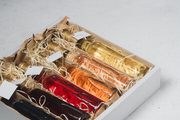 Assortment of 250 ml bottles of red, pink, white wine in box of wooden shavings, no label. Set of...