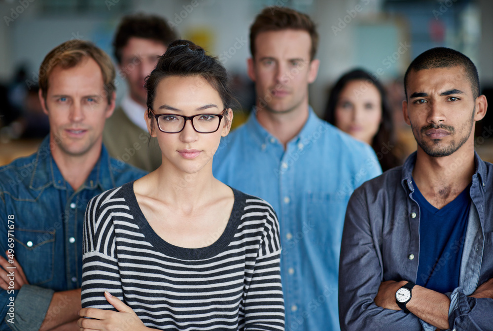 Wall mural they go after what they want. portrait of a serious group of businesspeople with arms crossed.