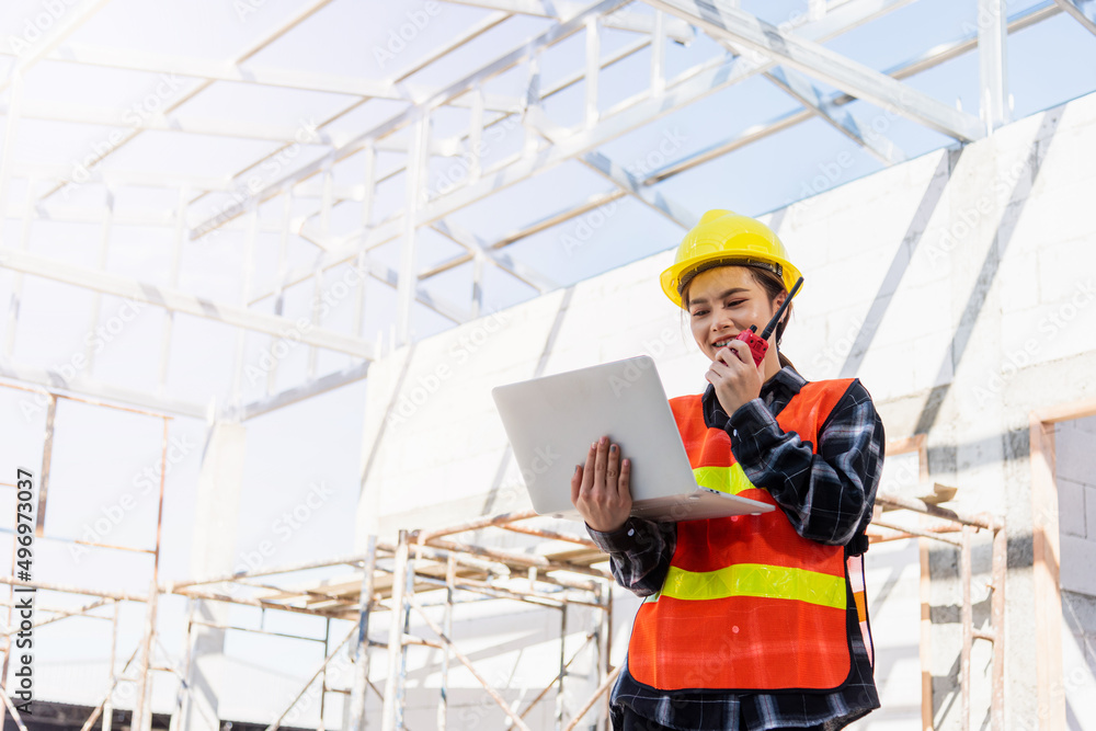 Poster asian engineer architect worker woman working at build construction site use laptop and talking with