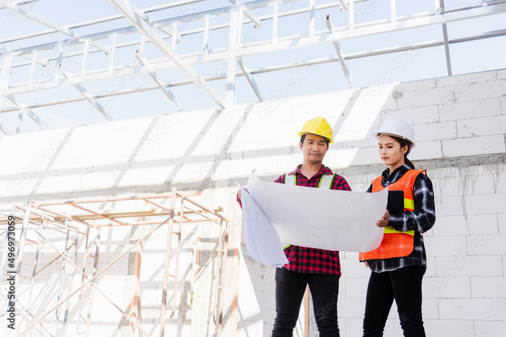 Poster architect and client discussing the plan with blueprint of the building at construction site. asian 