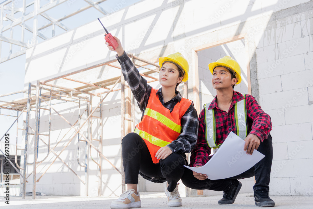 Poster architect and client discussing help create plan with blueprint of the building at construction site