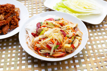Spicy green papaya salad with vermicelli.