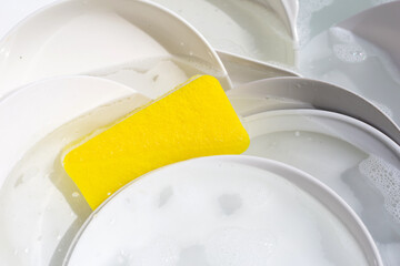 Dish washing, Dirty dishes soaking in kitchen sink.