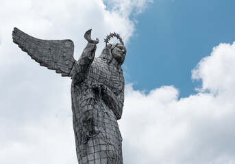 Statue Virgin of "El Panecillo", an icon of Quito's downtown on a cloudy day. Ecuador's religion and touristic destination concept.