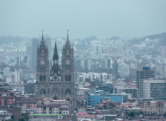 Cityscape view of Quito's historic downtown including the iconic Basilica church during a cloudy day. Ecuador's touristic destinations.