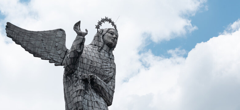 Statue Virgin of "El Panecillo", an icon of Quito's downtown on a cloudy day. Ecuador's religion and touristic destination concept.