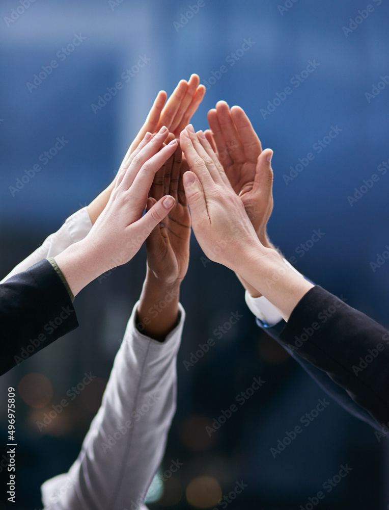 Leinwandbilder one team working towards one dream. shot of a group of colleagues giving each other a high five in a