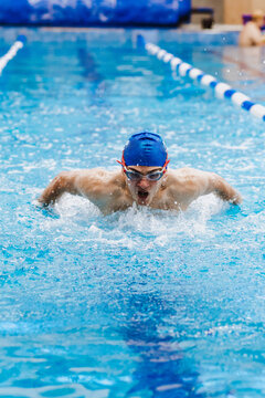 Hispanic Young Man Swimmer Athlete Wearing Cap And Goggles In A Swimming Training At The Pool In Mexico Latin America	