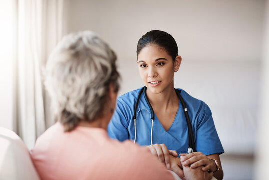 Im here for you...always. Cropped shot of an attractive young nurse holding a senior womans hands in comfort.