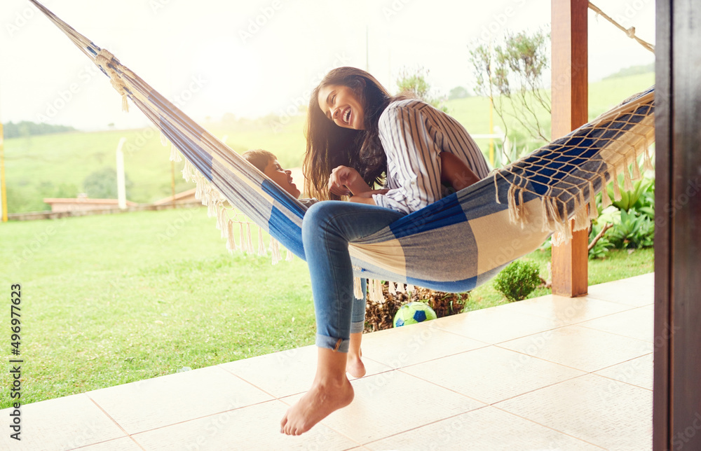 Sticker Happiness on a hammock. Full length shot of an attractive young woman and her son bonding outside on the hammock.