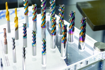 CNC cutters for metal. Multi-colored drills close-up. Accessories for engraving, milling, cutting of various metals. Cutters of different types. Monolithic milling tool. Solid carbide milling cutters - obrazy, fototapety, plakaty