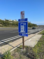 Road sign on the Pacific Coast Highway for Electric Vehicle fast charging station in Southern California.