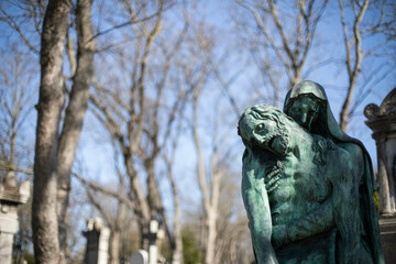 Statue of Mary holding Jesus at Pere Lachaise Cemetery