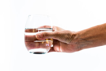 hand offering glass with pure water, white background